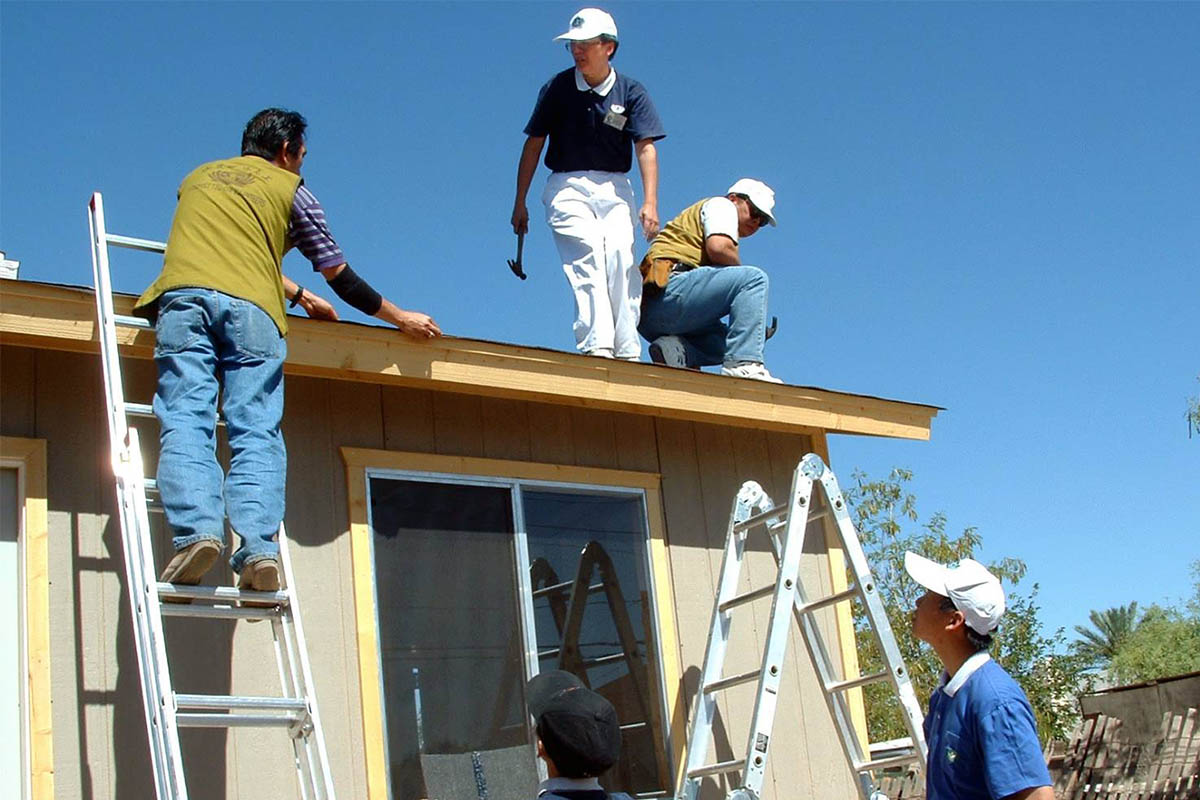 Volunteers work on the construction of the house under the blazing Arizona sun.