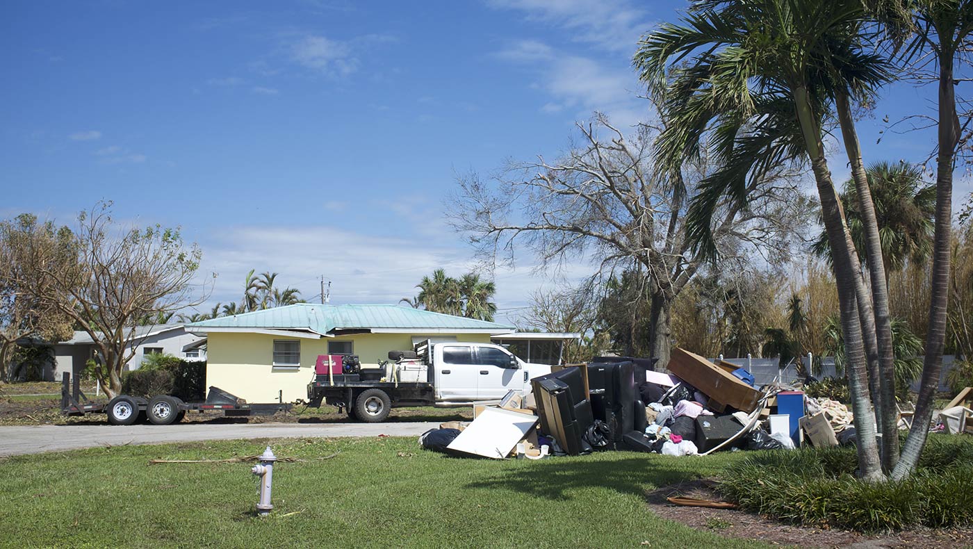 Local community residents in Cape Coral continue cleaning out homes after flood water saturates their possessions. Photo/Qihua Luo