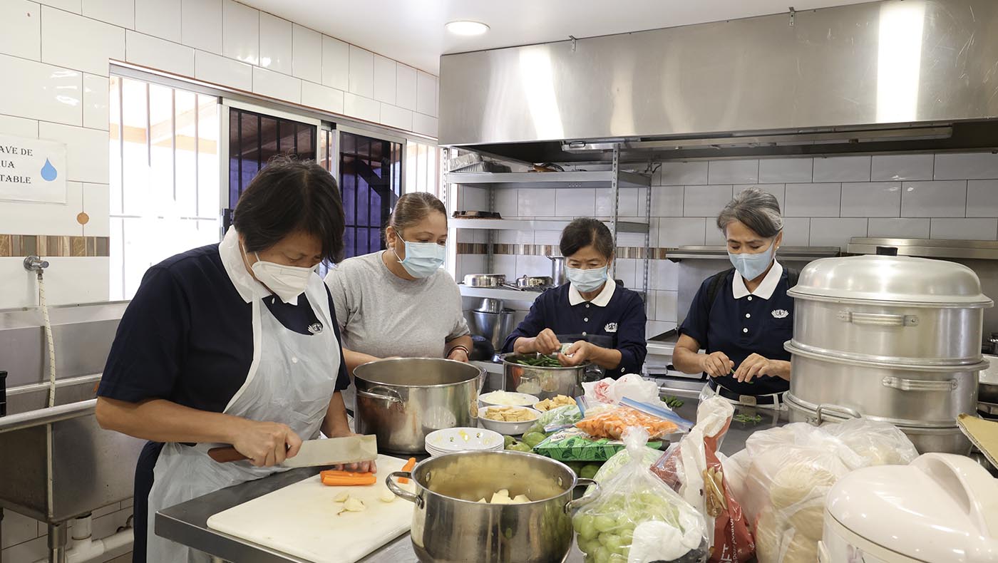Tzu Chi volunteers cook a vegetarian dinner for the Lucero Dental Group team