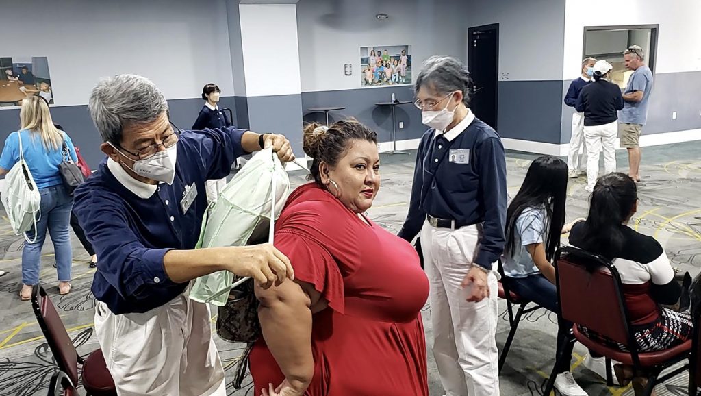 Volunteers help survivors with their care packages of relief supplies