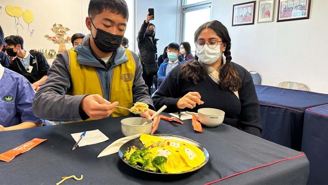 Sacramento Tzu Shao enjoying food from Veggie Promote Chef Competition