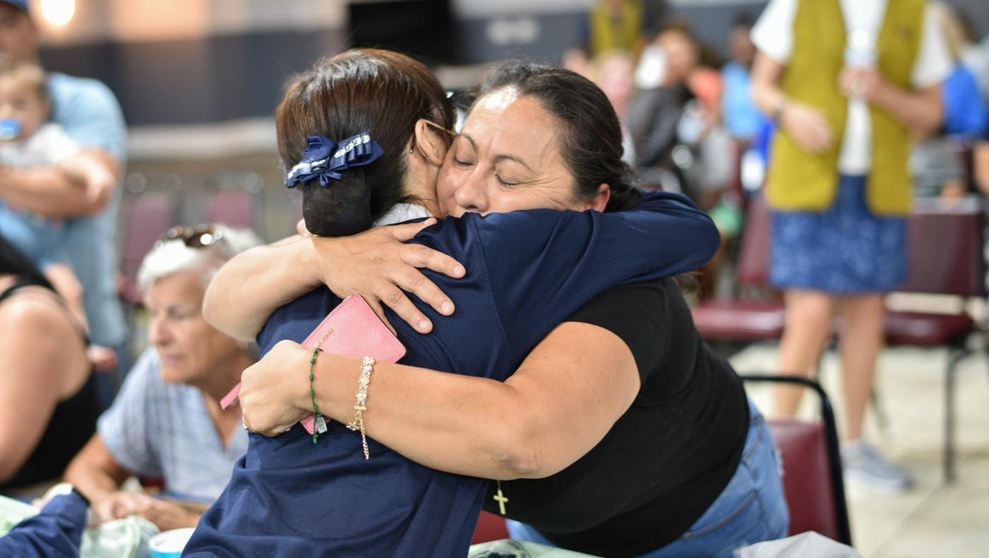 Fort Myers distribution volunteer and recipient hugging