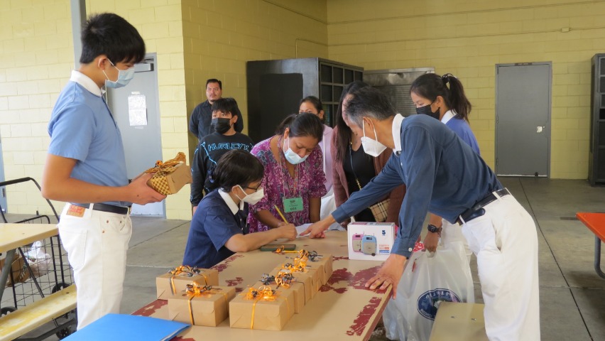 Volunteers distribute beautiful gift boxes