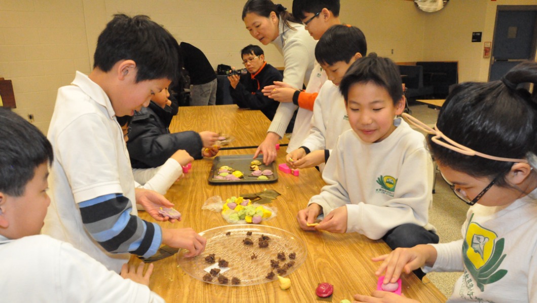 Tzu Chi Acadmy teacher and students making Chinese sweet dumplings together