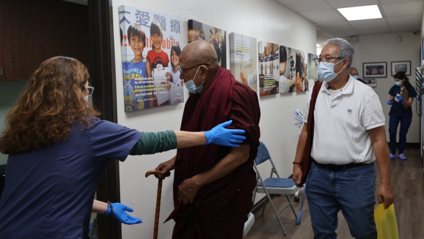 Tzu Chi volunteer guiding Myanmar Monk to the consulting room