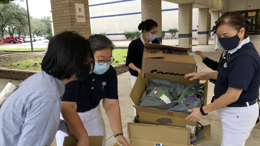 Tzu Chi volunteers delivering and organising distribution items