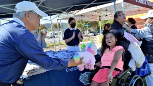 Tzu Chi volunteer giving free toy to disable girl