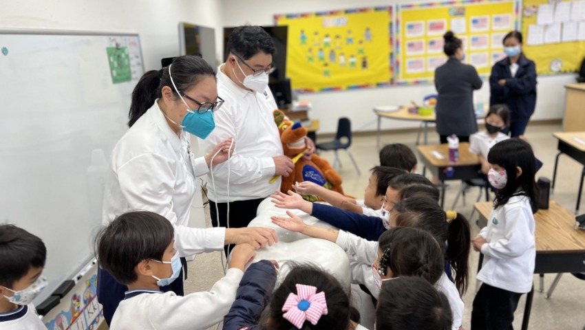 Tzu Chi Walnut Elementary School students learning how to floss the teeth correctly