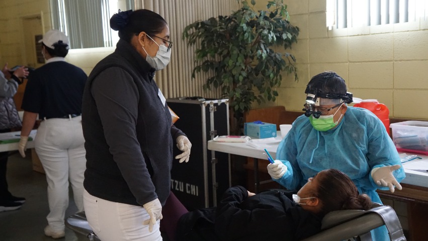 Tzu Chi TIMA dentist offering dental check up for recipient in Fresno