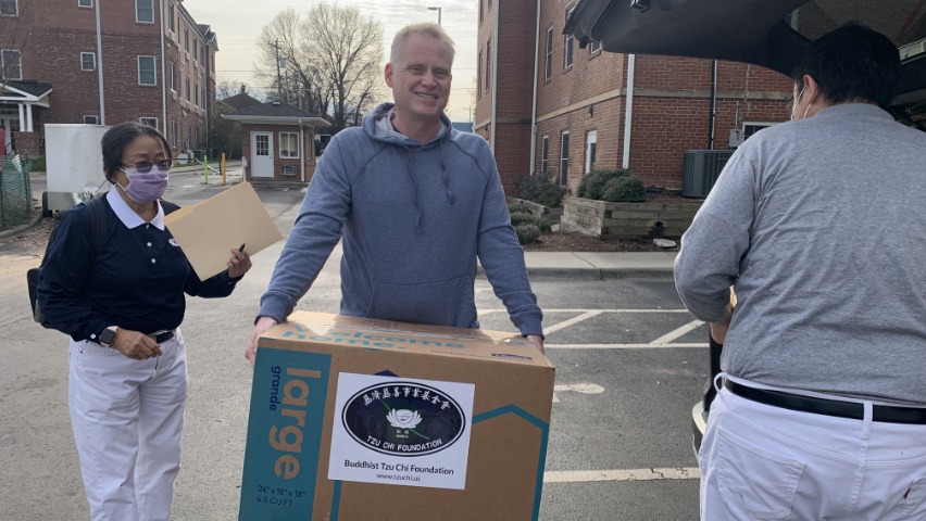 Mr. Matthew receives the donations with a smile