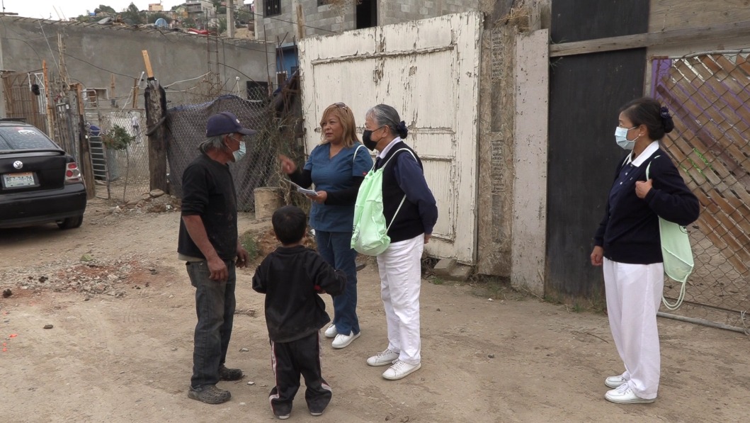 Tzu Chi volunteer talking to people in Tijuana