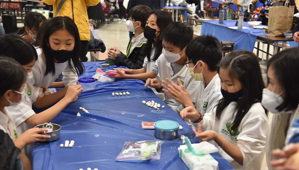 Tzu Chi Academy students making Chinese sweet dumplings together