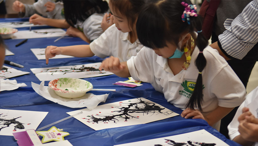 Tzu Chi Academy students creating ink painting