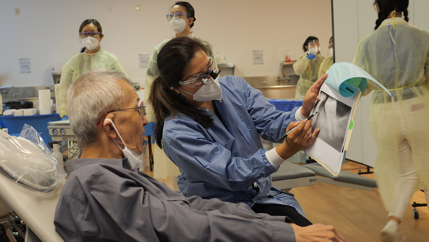 Dental medical volunteers look at X-rays for diagnosis