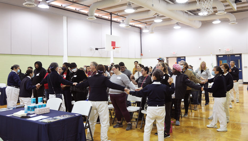 Tzu Chi USA volunteers and Houston Tornado Recipients practicing sing language song together