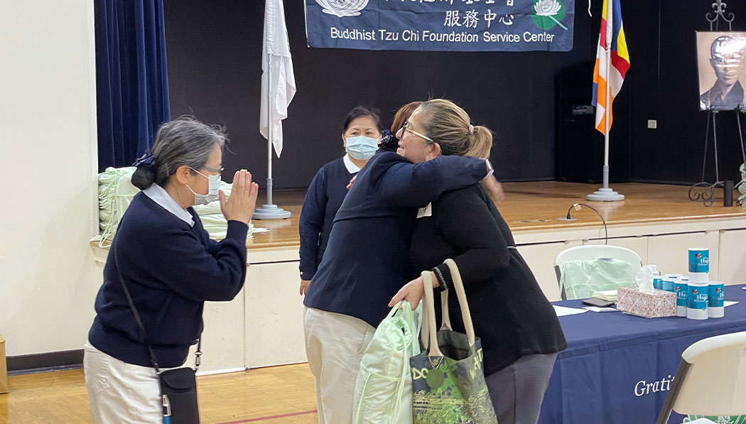 Tzu Chi USA volunteers and Houston Tornado Relief hugging each other
