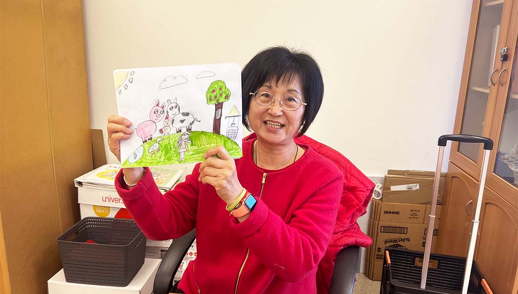 Tzu Chi Education Foundation's teacher happily showing her student's vegan promotion drawing