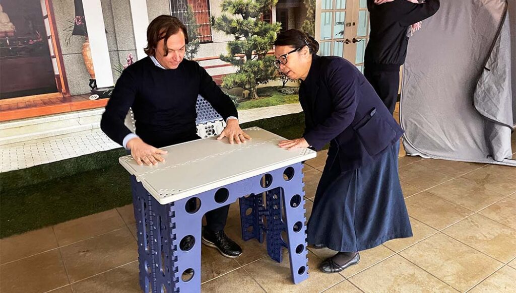 Representative of Adventist Development and Relief Agency trying Tzu Chi’s proprietary and award-winning multipurpose furniture.