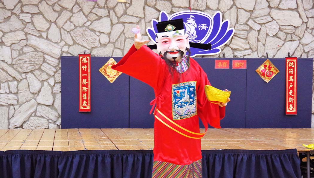 Parent dress up as god of wealth for the Tzu Chi Academy Lunar New Year blessing celebration