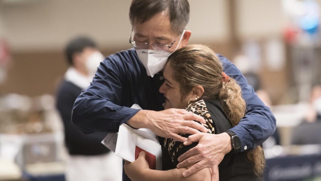 Tzu Chi Northwest volunteers embracing survivor