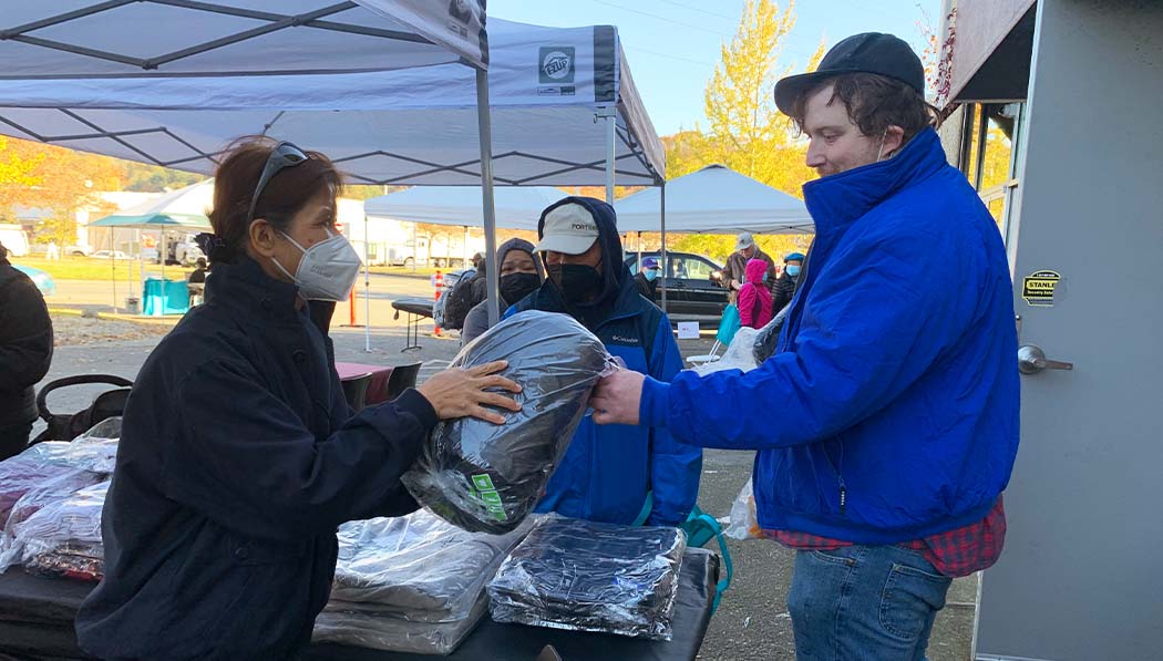 Tzu Chi volunteers distributing eco blanket