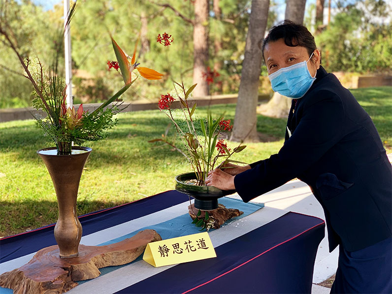 Tzu Chi volunteer and her floral arrangement