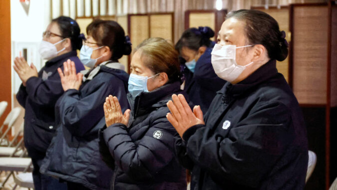 Tzu Chi volunteers praying