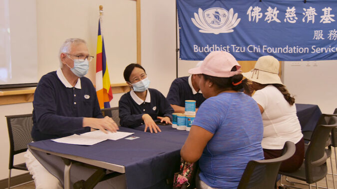 Tzu Chi volunteers listening to the care recipient