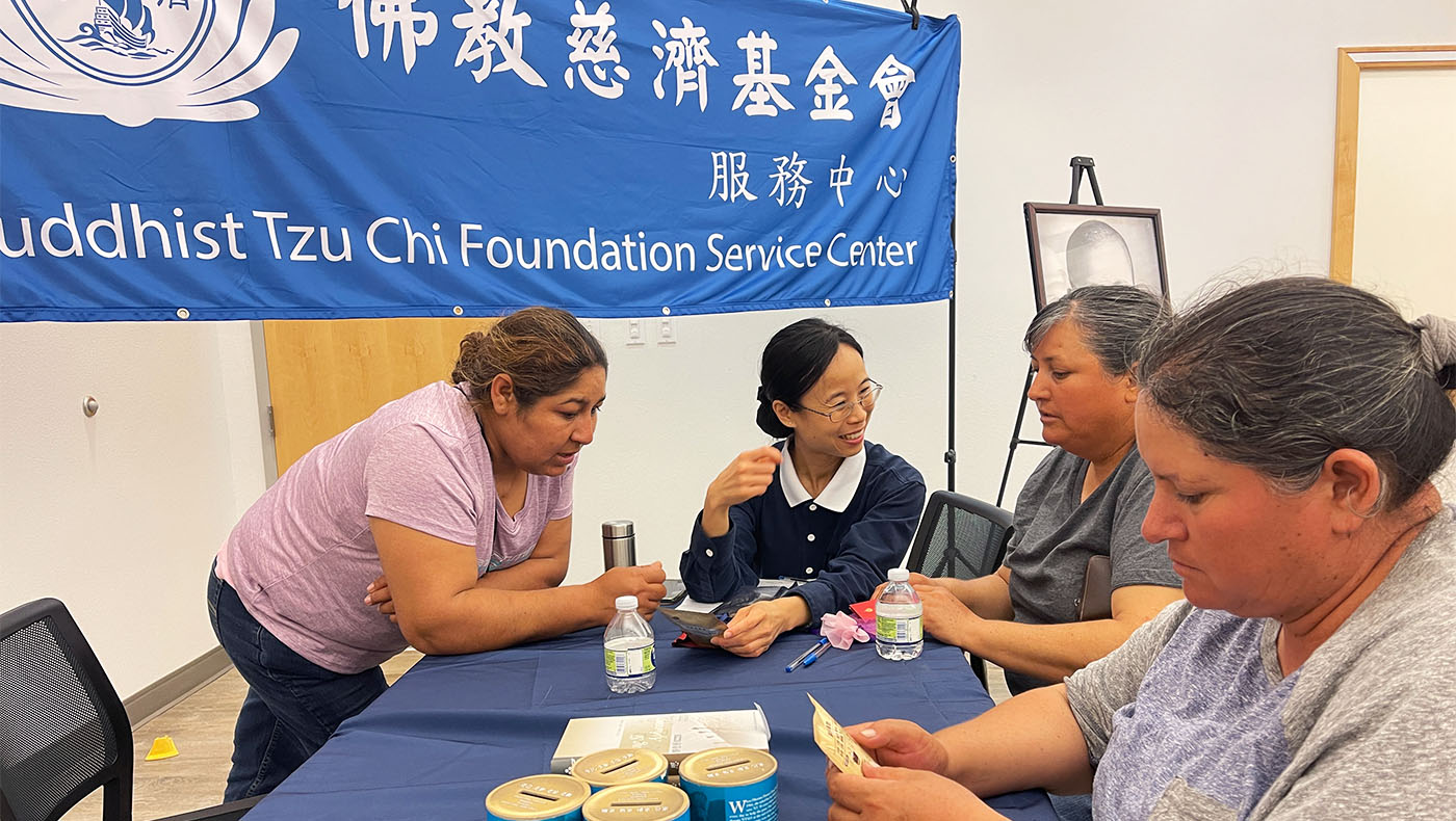 Care recipients receiving Tzu Chi blessing pouch