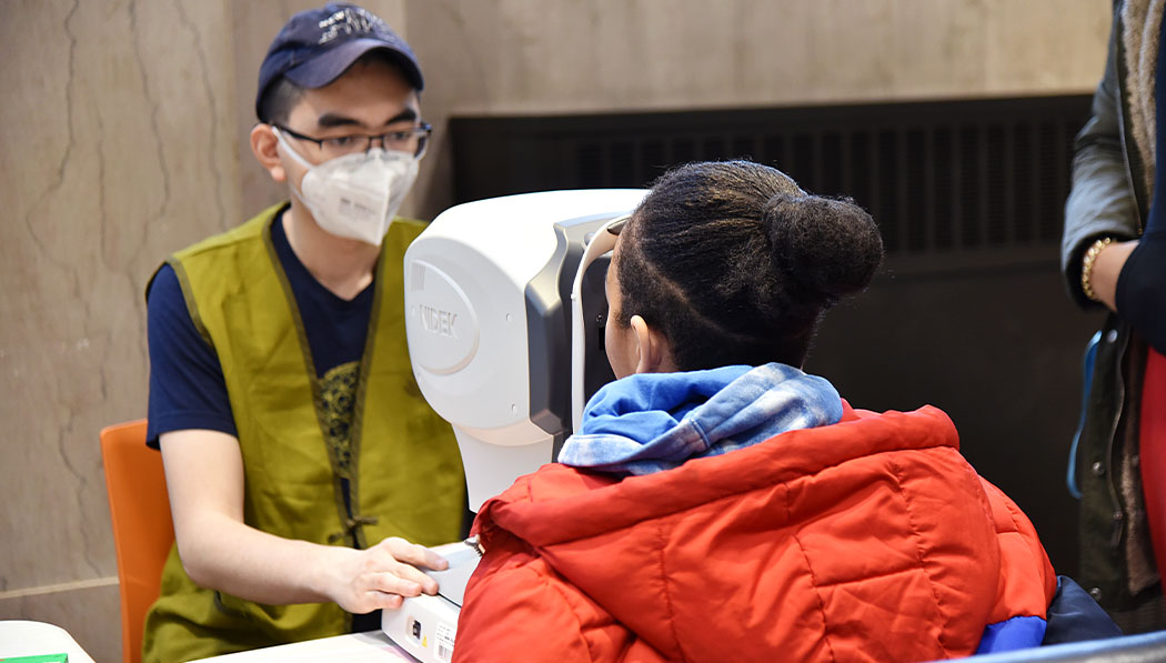 Volunteers giving optical checkups for young neighbor