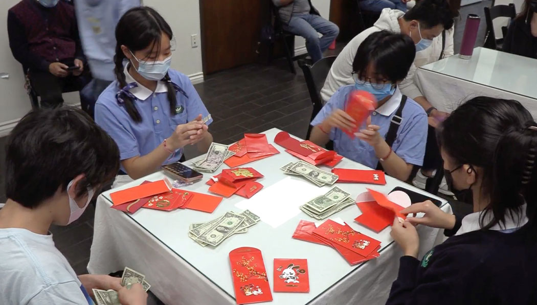 Tzu Shao organizing red envelopes together