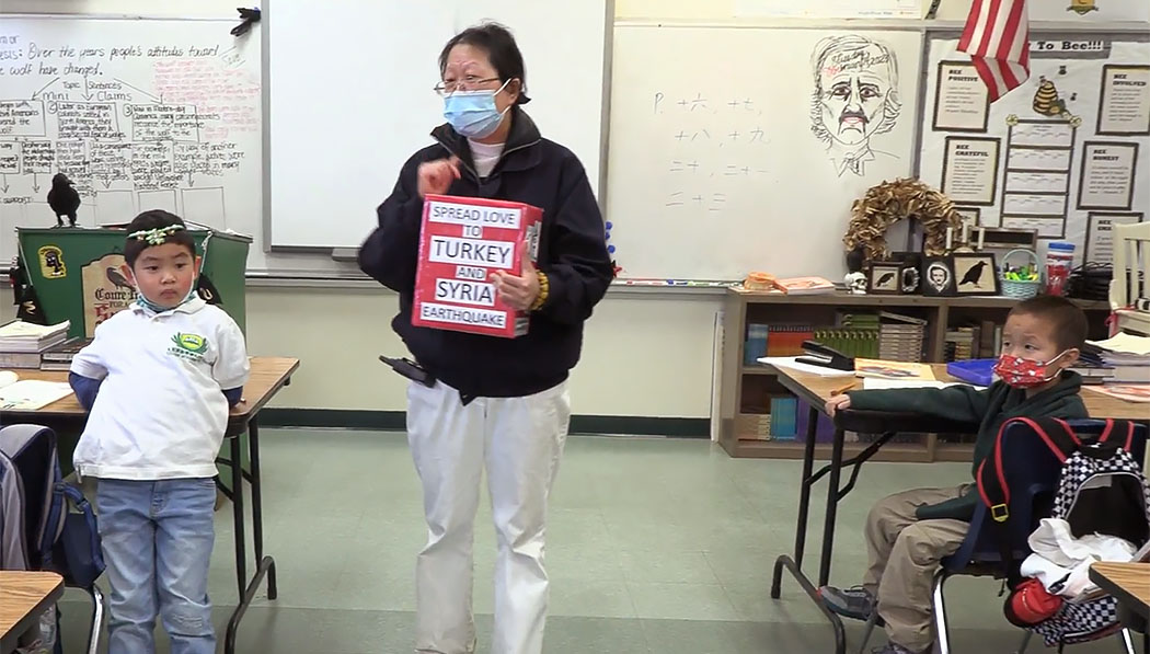 Tzu Chi Academt teacher encouraging students to donate