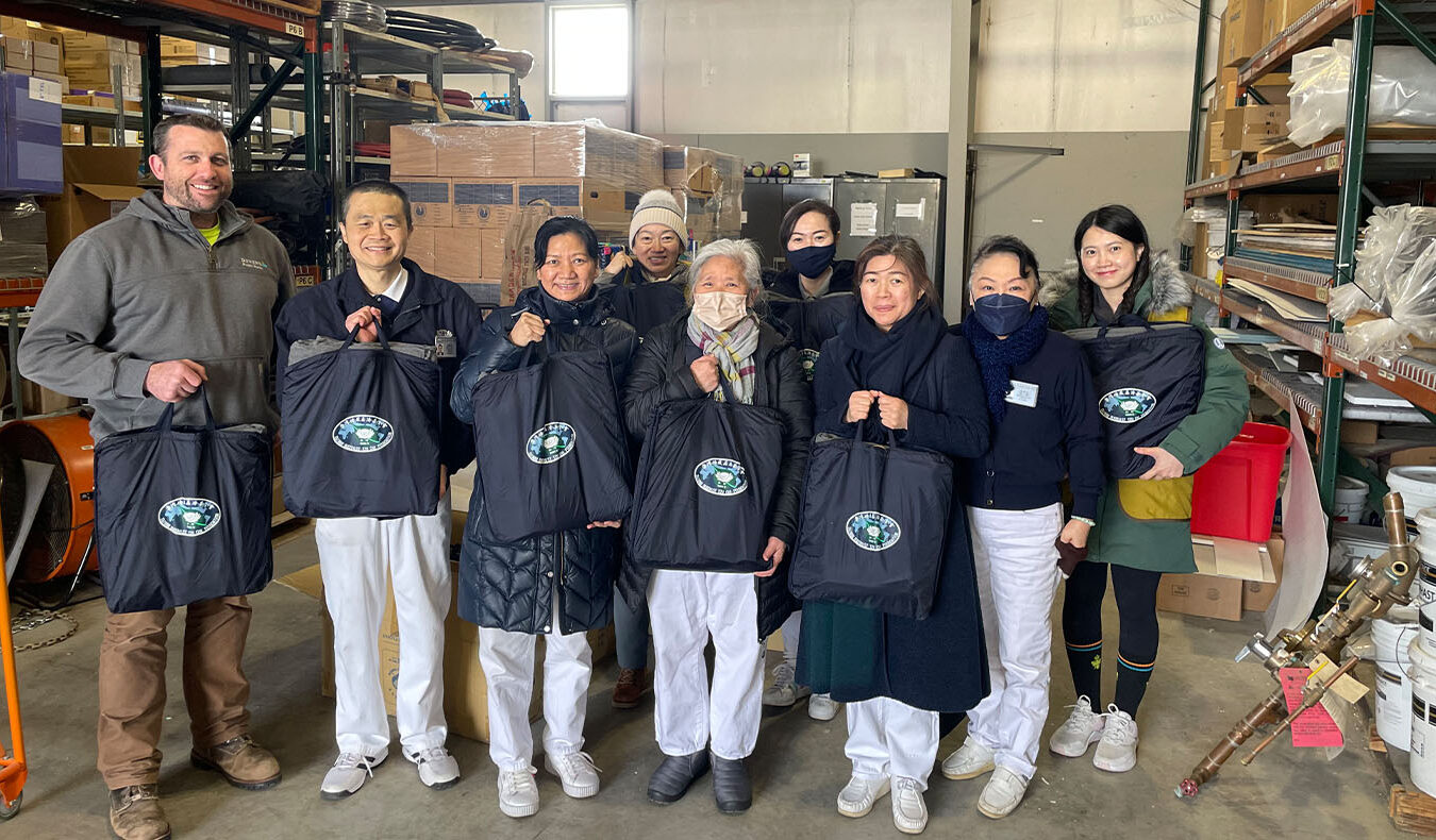 Tzu Chi volunteers and undertaker holding care package group photo