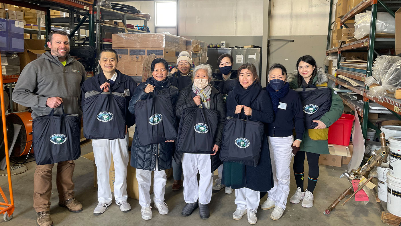 Tzu Chi volunteers and undertaker holding care package group photo