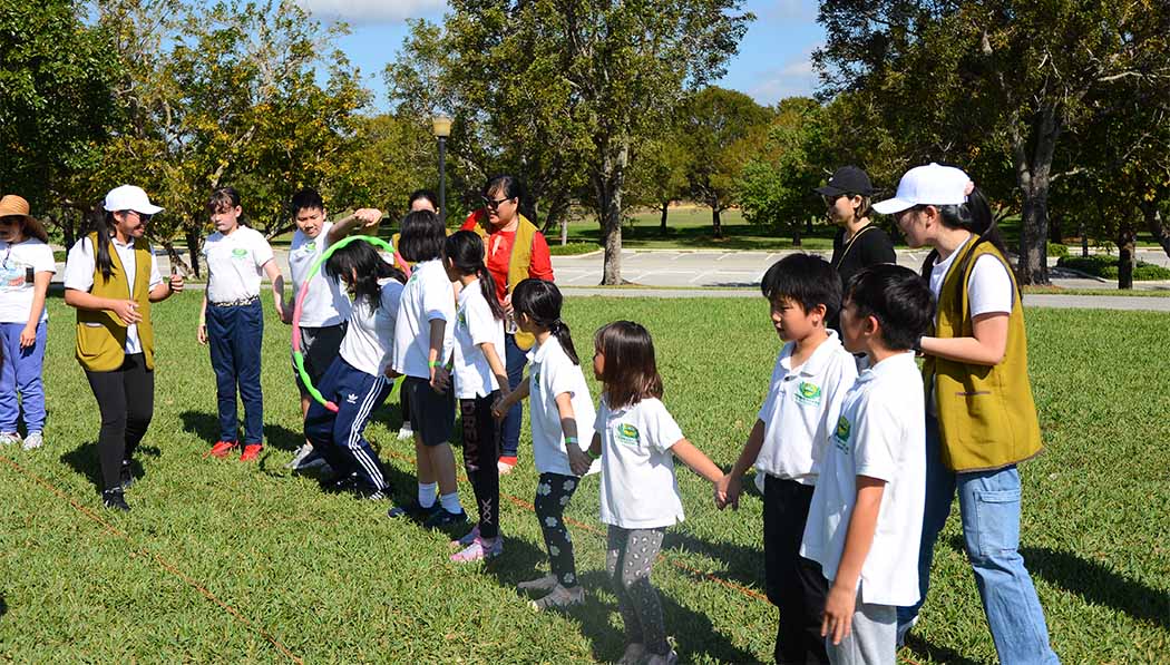 Tzu Chi Miami Academy student holding hands in a line