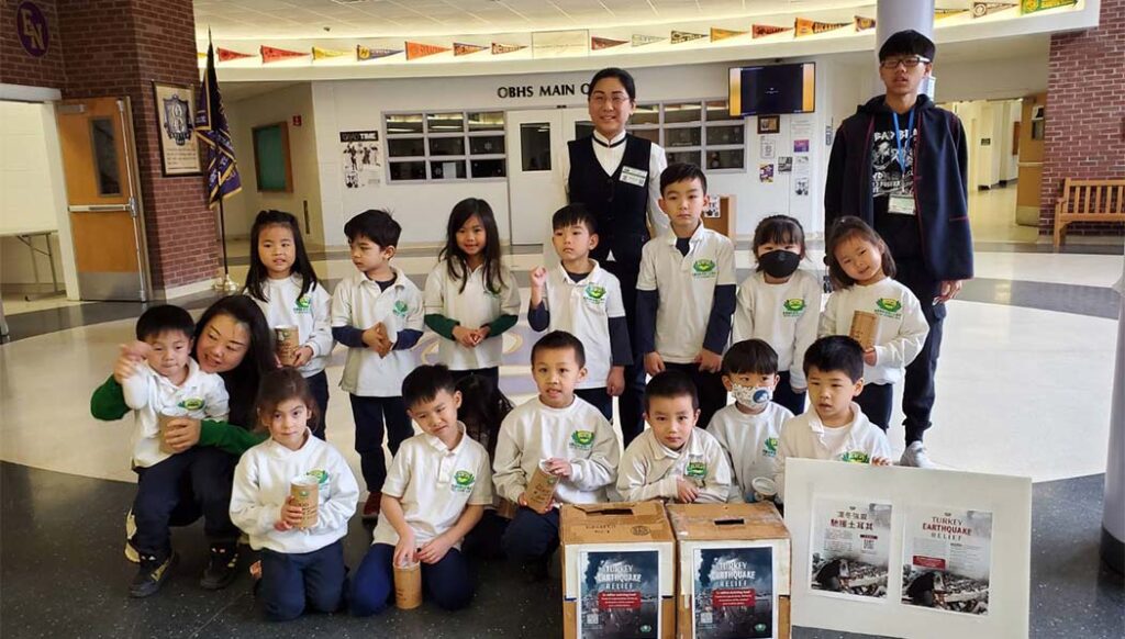 Tzu Chi Academy, Lomg Island teachers and students group photo with Turkey earthquake relief posters