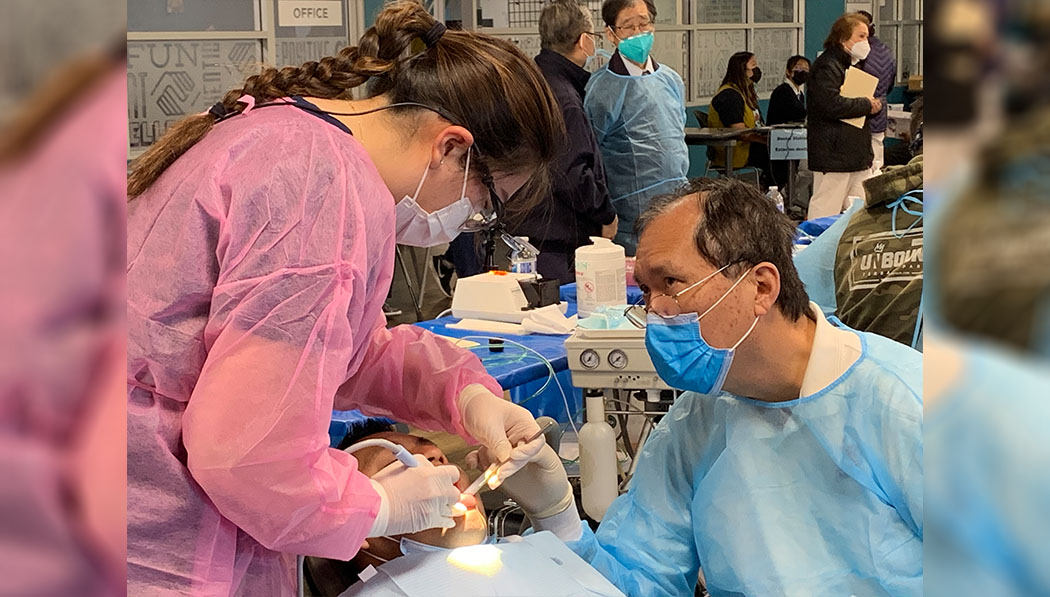 Tzu Chi volunteers dentist and assistant dentist working closely