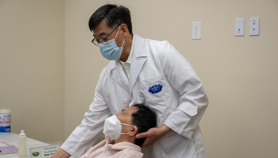 A Chinese medicine doctor examining a patient's spinal condition