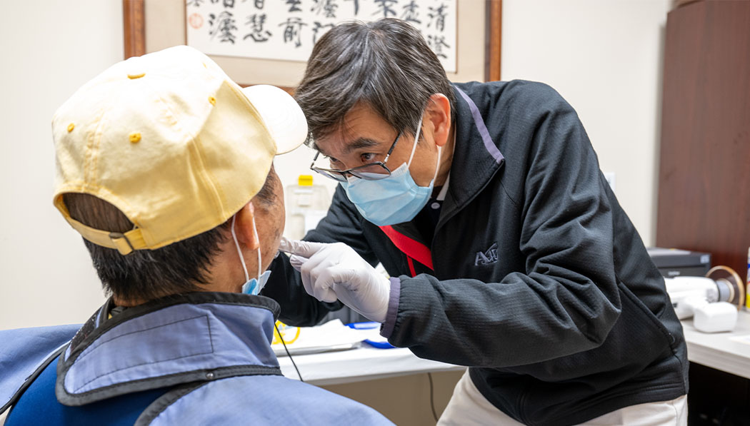 The dentist examining the patient's oral health