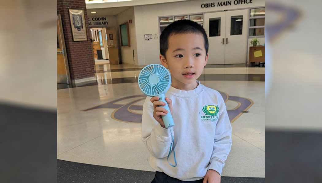 Long Island Academy student showing his recycle electronic fan