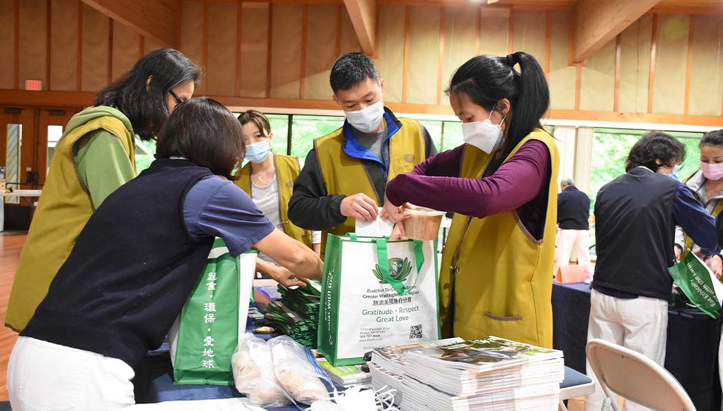 Tzu Chi volunteers packing flyers and materials in bags