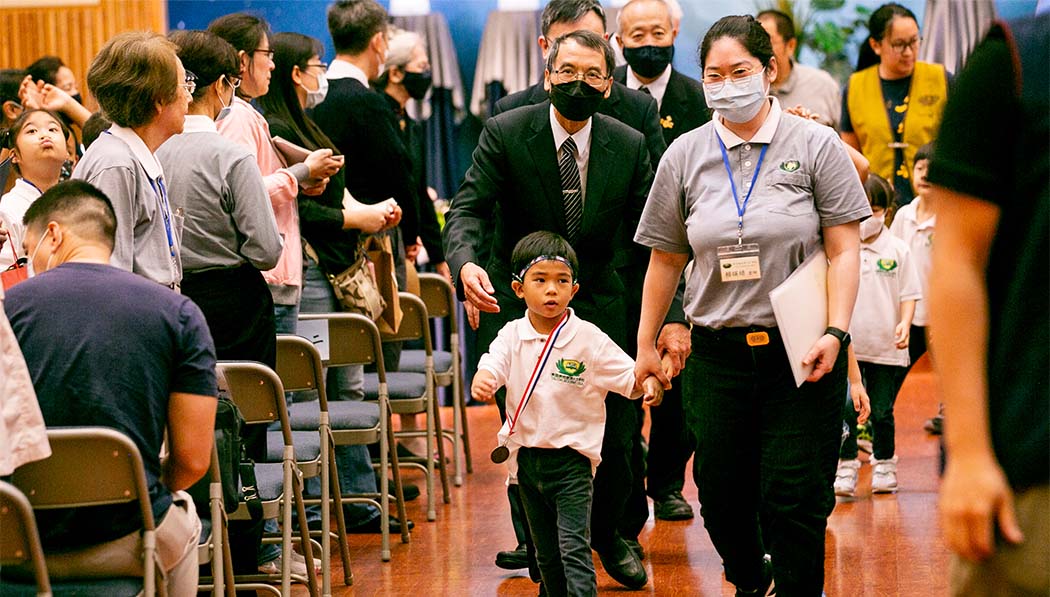 Tzu Chi Houston Academy young student walking into the graduation ceremony