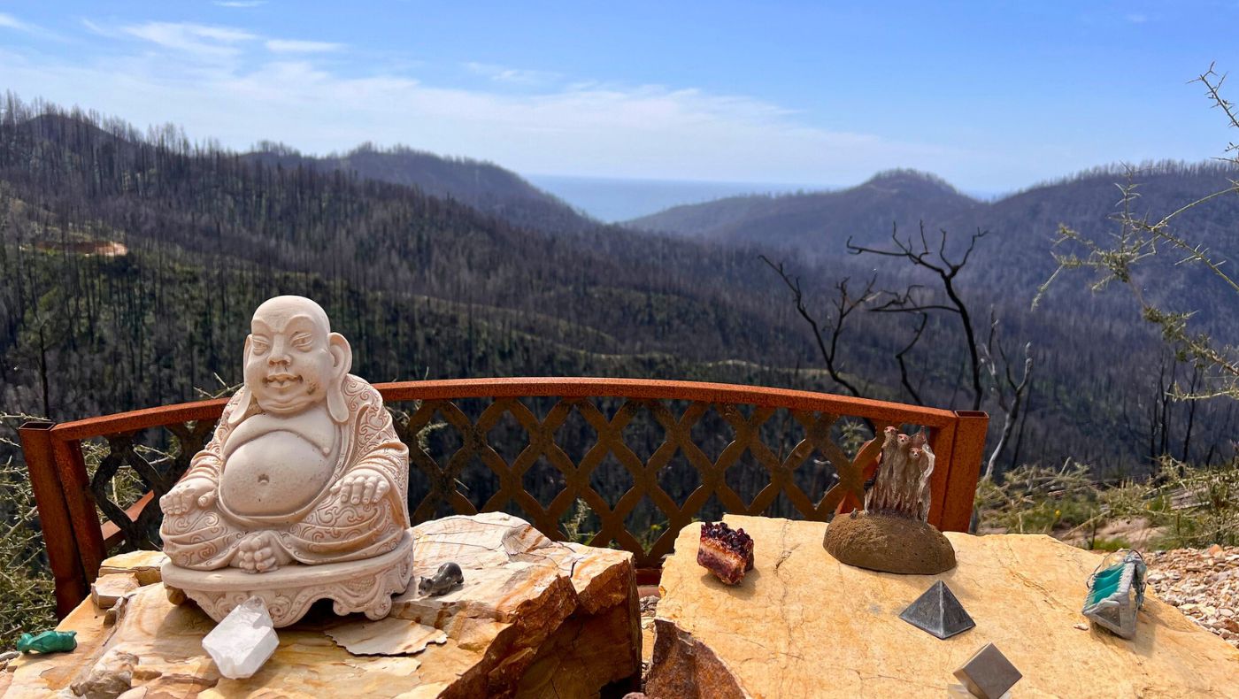 A Buddha statue appears on the road, a gift from Jacob Guth’s father from when he served in the Navy. He placed the statue halfway up the hill to protect the land. Photo/Judy Liao