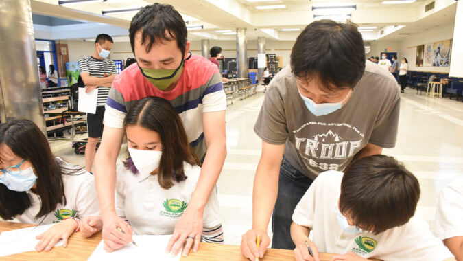 Tzu Chi DC Academy students drawing with their parents