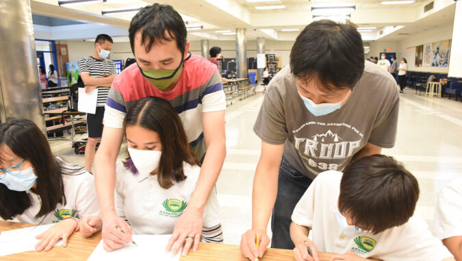 Tzu Chi DC Academy students drawing with their parents