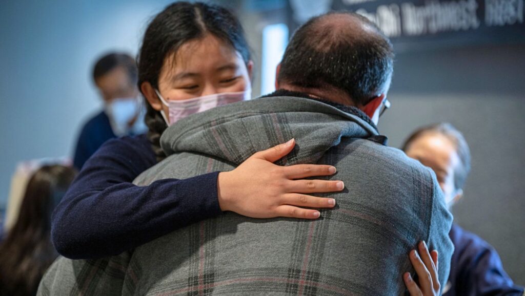 survivors and Tzu Chi volunteers embrace each other with affection