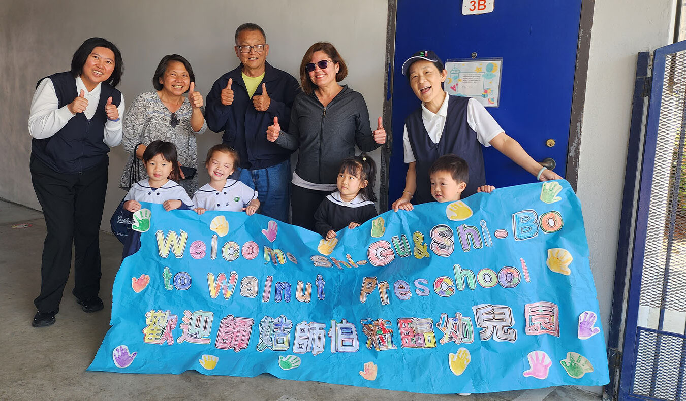 Tzu Chi USA Education Foundation CEO, students, Miriam Echeverria group photo with welcoming banner