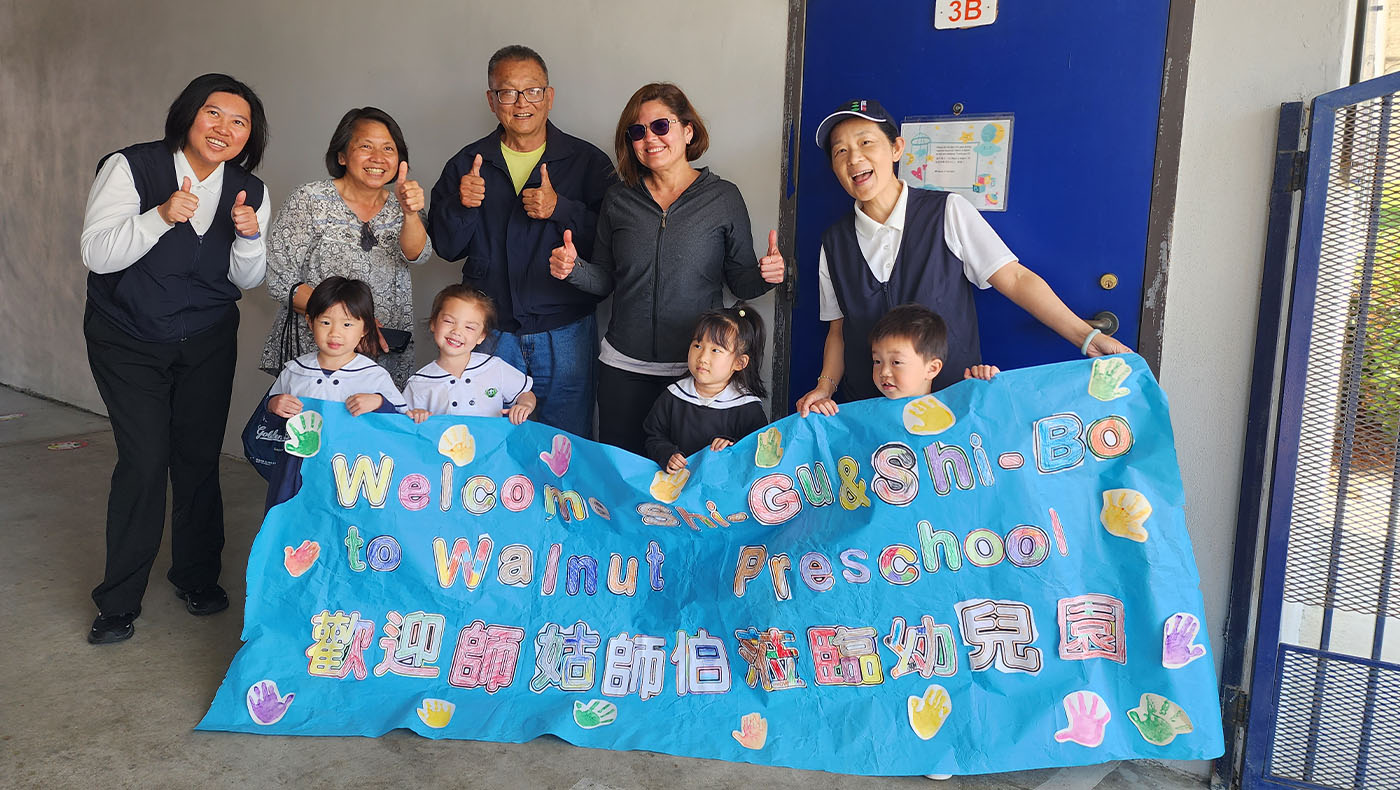 Tzu Chi USA Education Foundation CEO, students, Miriam Echeverria group photo with welcoming banner