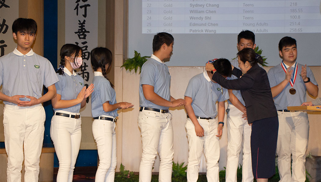 Tzu Shao receiving their president volunteer reward
