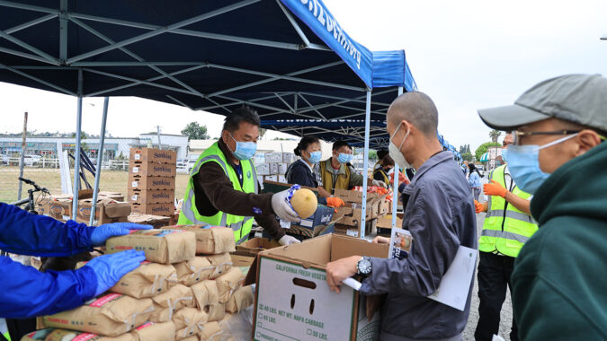 Tzu Chi volunteers distributing supplies to the Chinese immigrants